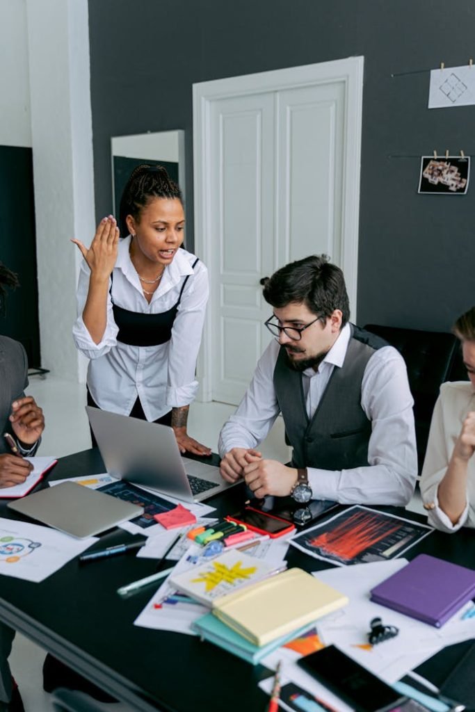 Business team in office, engaged in a serious discussion over deadlines and strategies.